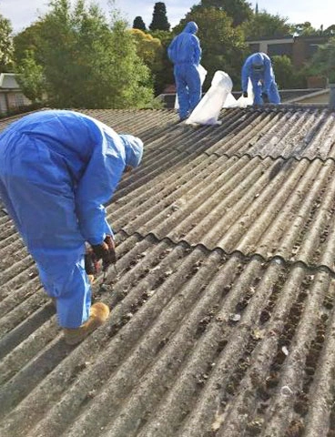 Team removing asbestos from roof of building . Work done by Top Gun Plant Hire, Loganholme Brisbane.